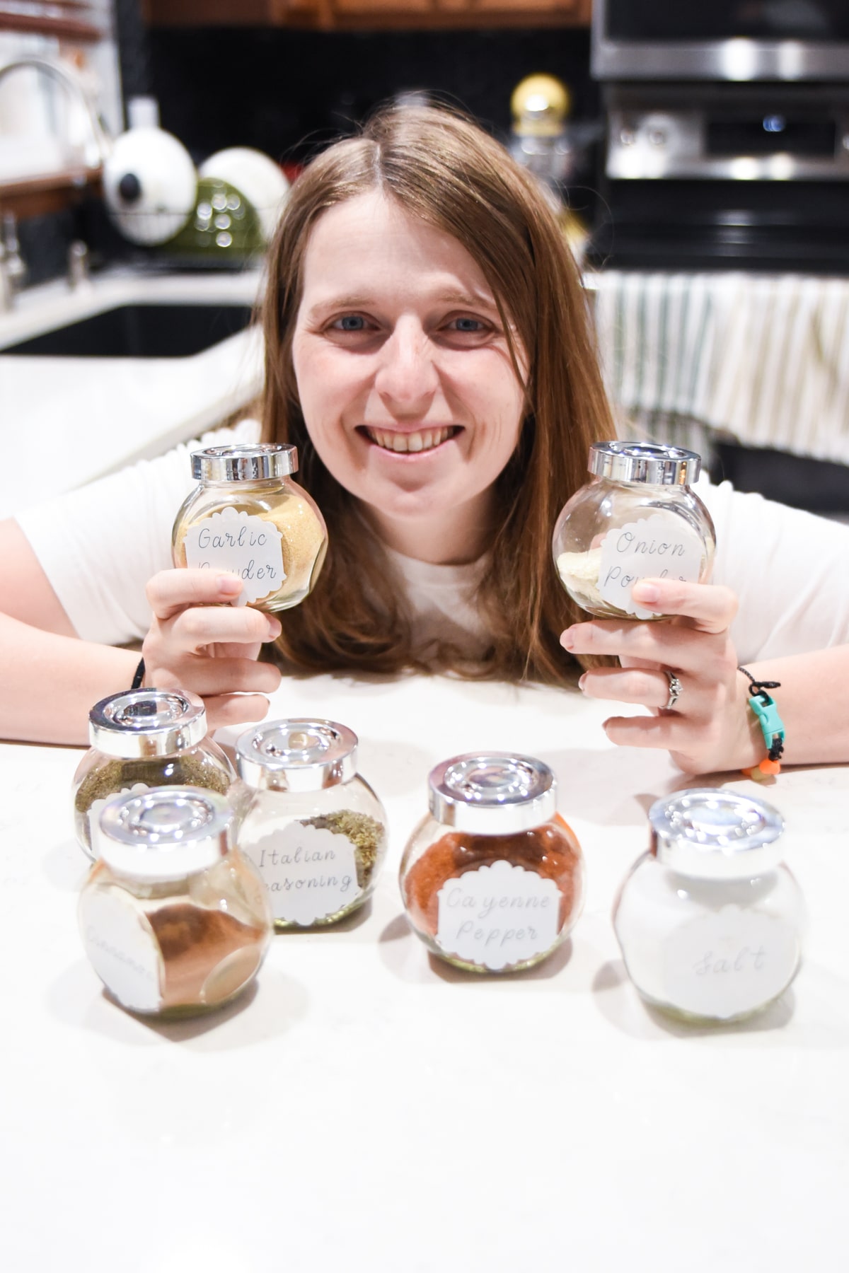 A woman holding spice jars