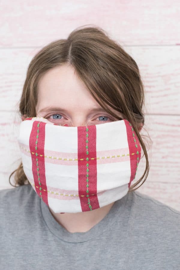 A person wearing a hand towel mask