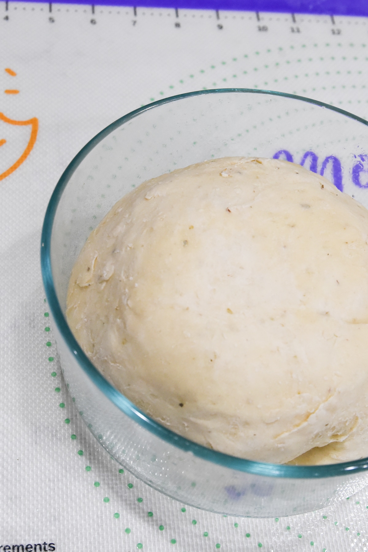 sourdough pizza crust rising in a  bowl