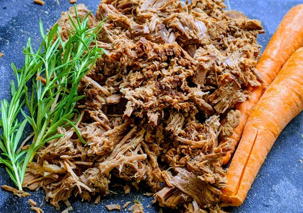 shredded roast beef by carrots and sprigs of rosmeary. 