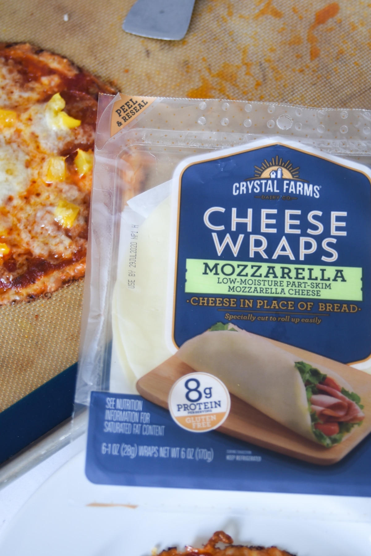 Crystal Farms Cheese Wraps next to a cheese pizza crust