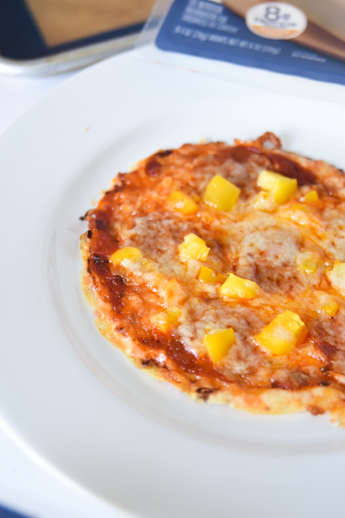 Easy low carb pizza that is crustless. Plated on a white plate. 