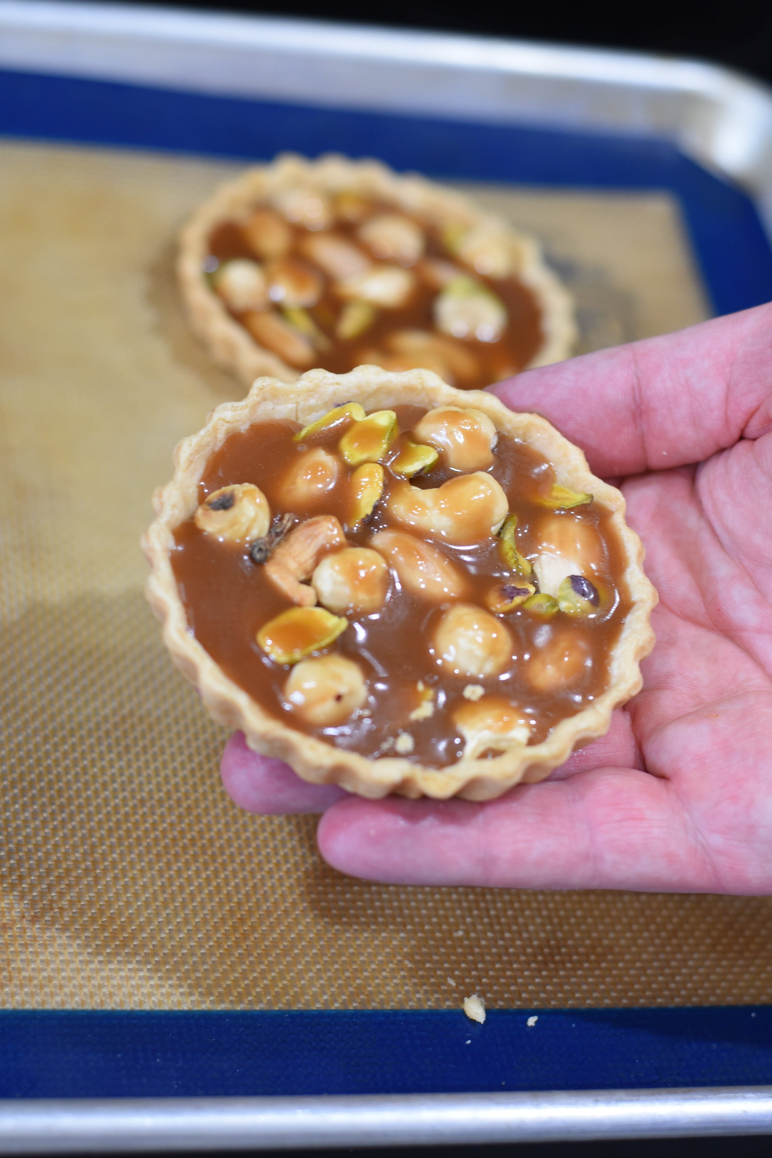 holding a wildgrain caramel tart