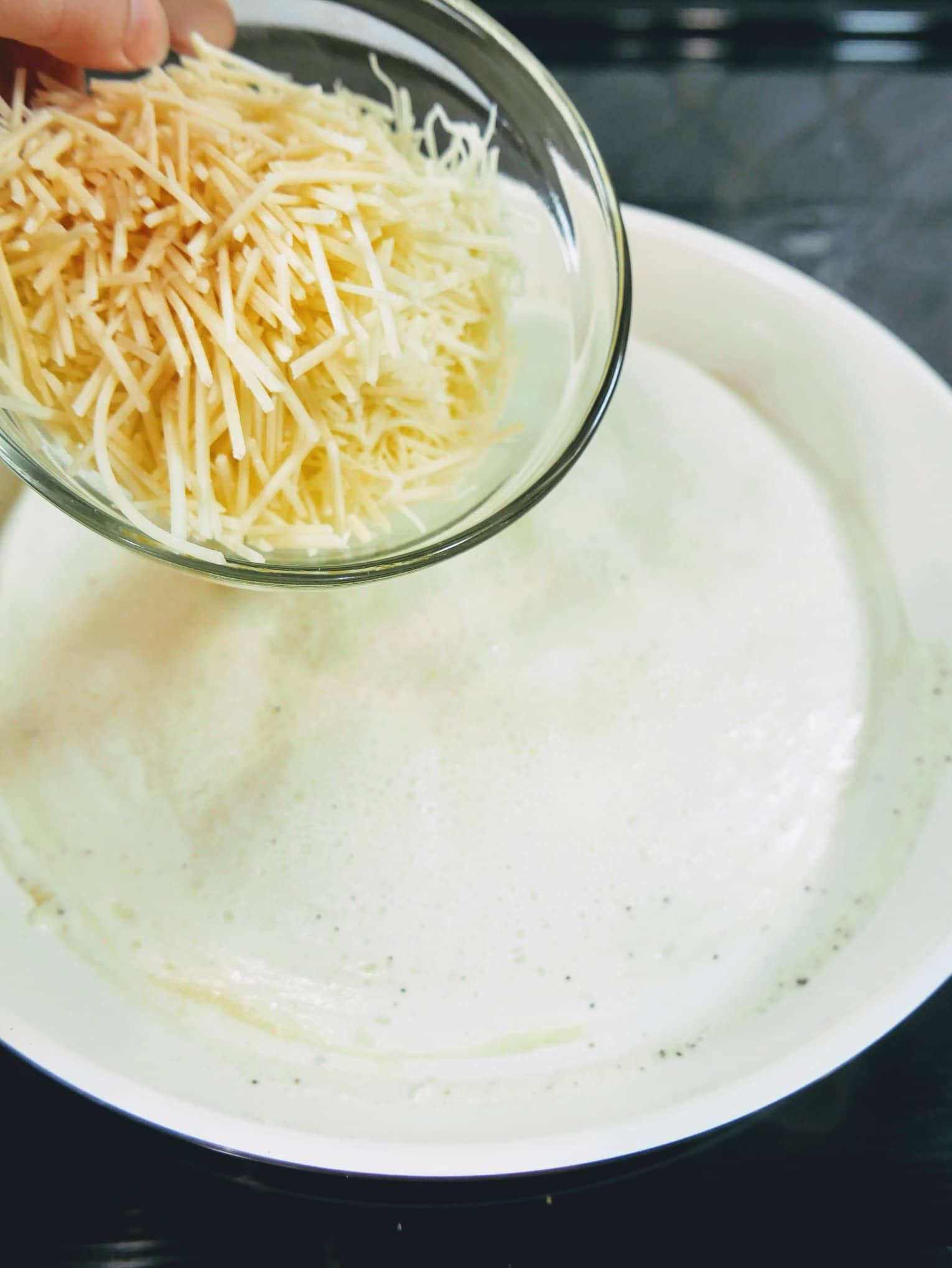 parmesan being poured into bowl