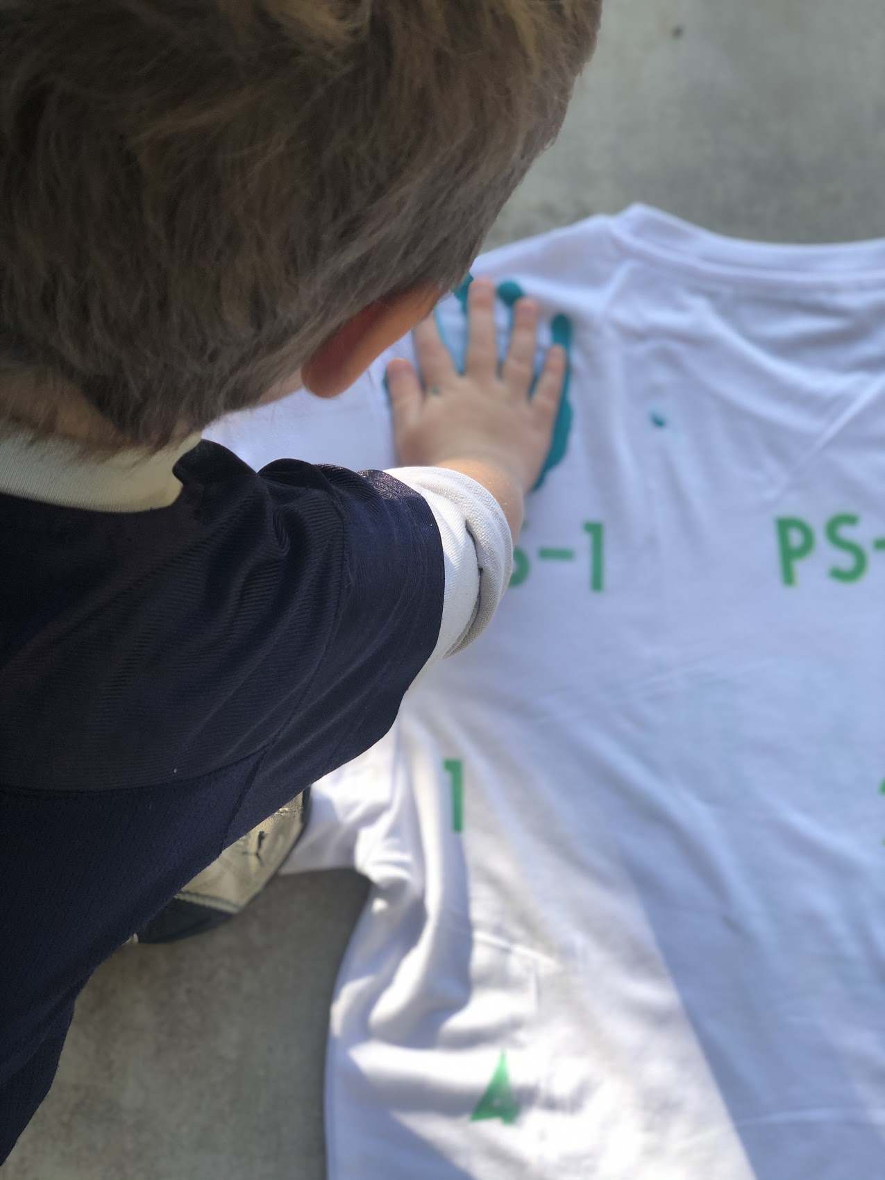 boy putting hand on t-shirt