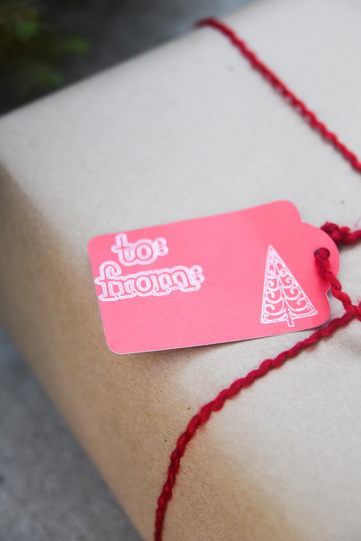 cricut christmas gift tag on a brown gift