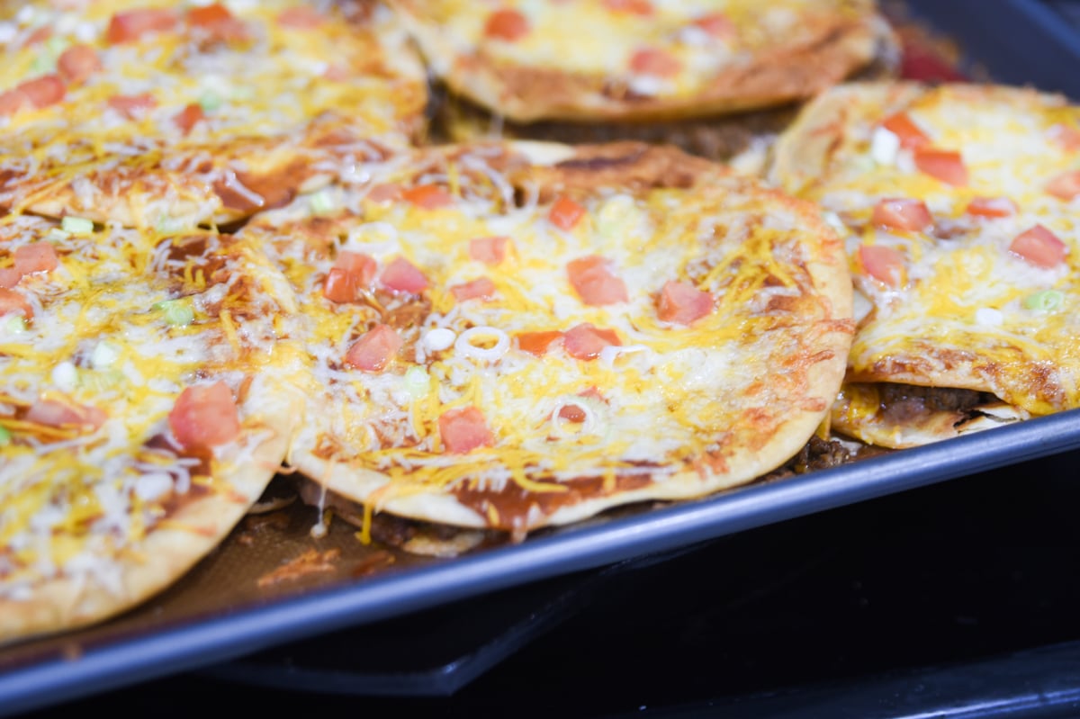 mexican pizzas on baking sheet