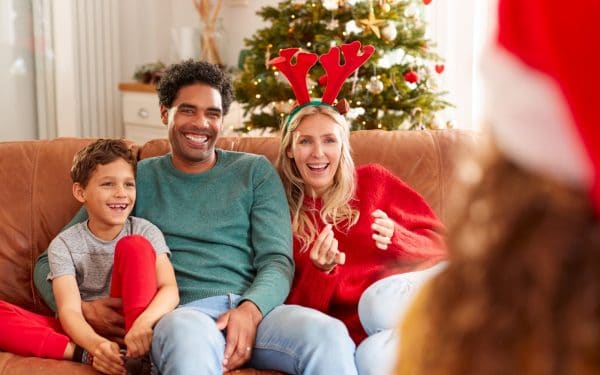 multi racial family sitting on a couch