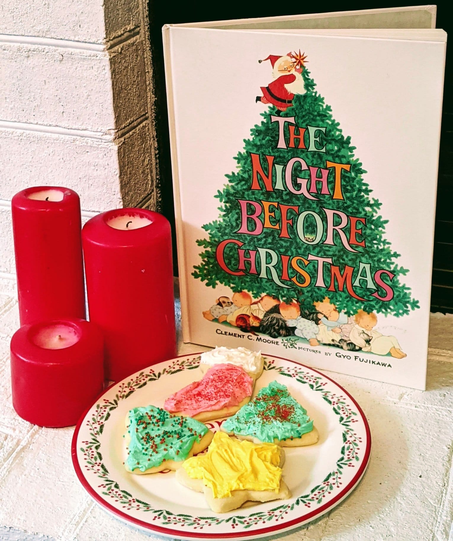 frosted sugar cookies in ront of Christmas book 