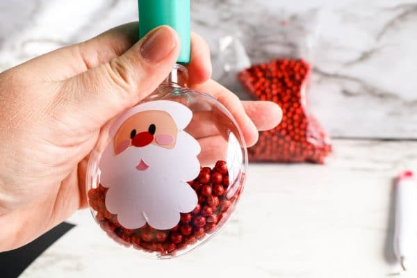pouring beads inside santa ornament