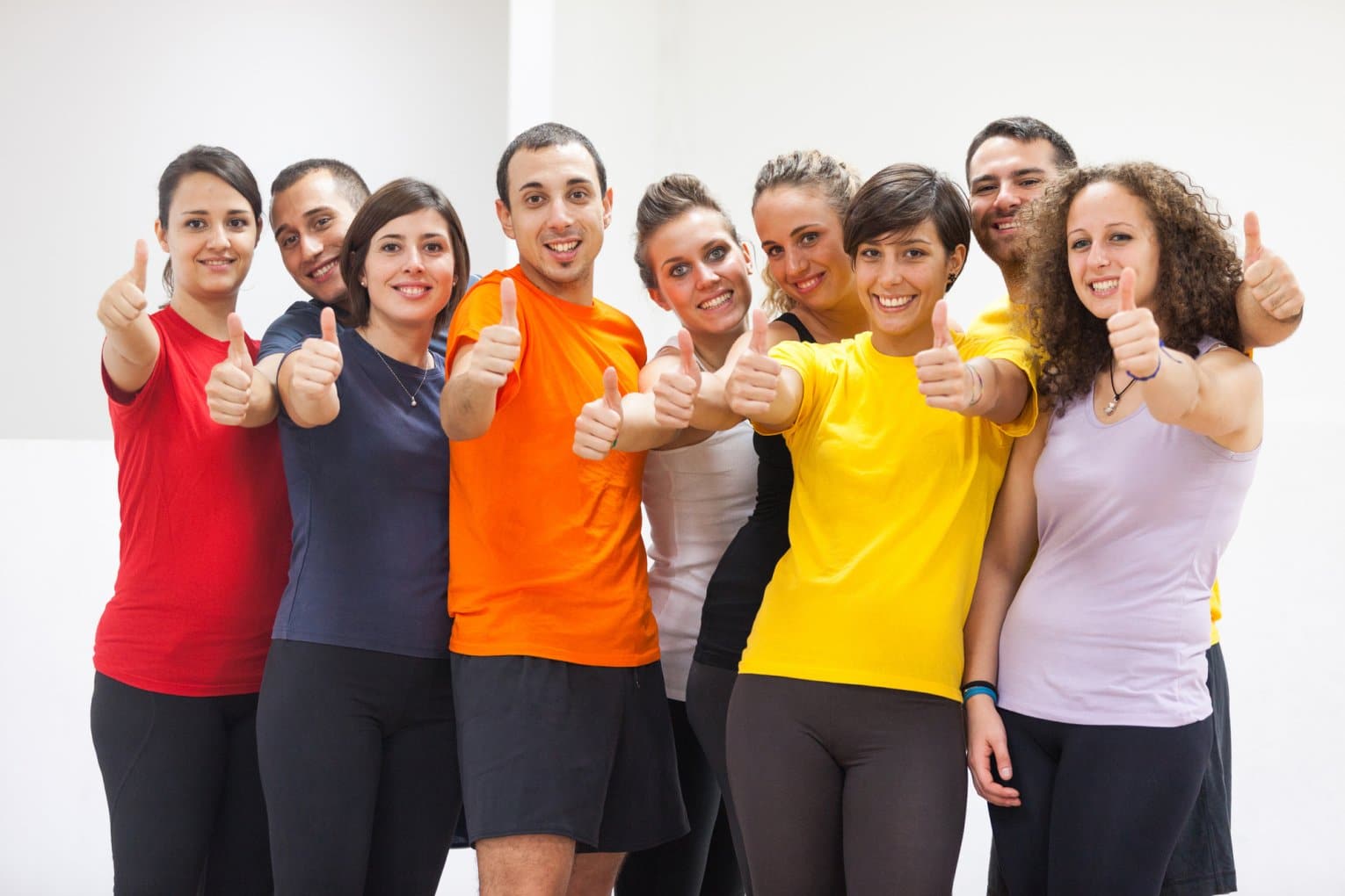 young adults exercising and giving thumbs up