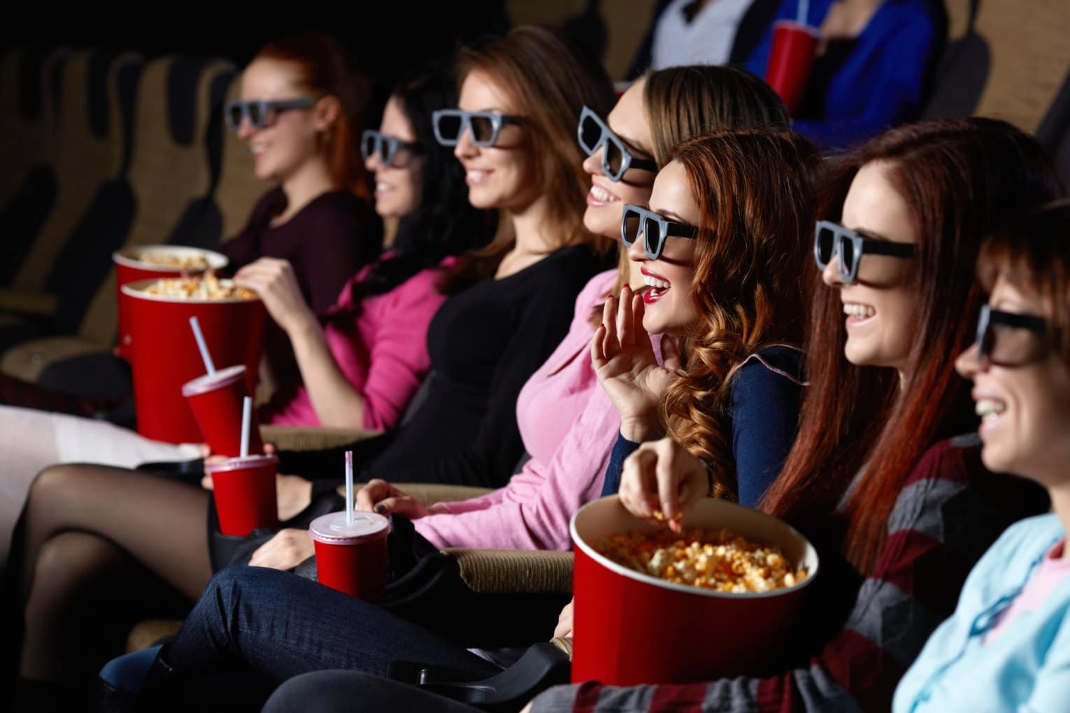 young adults watching movies with 3D glasses