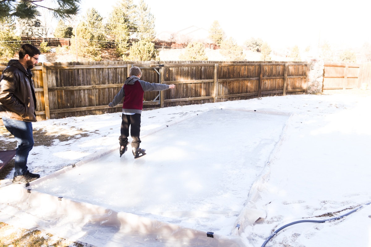 child ice skating in backyard ice rink