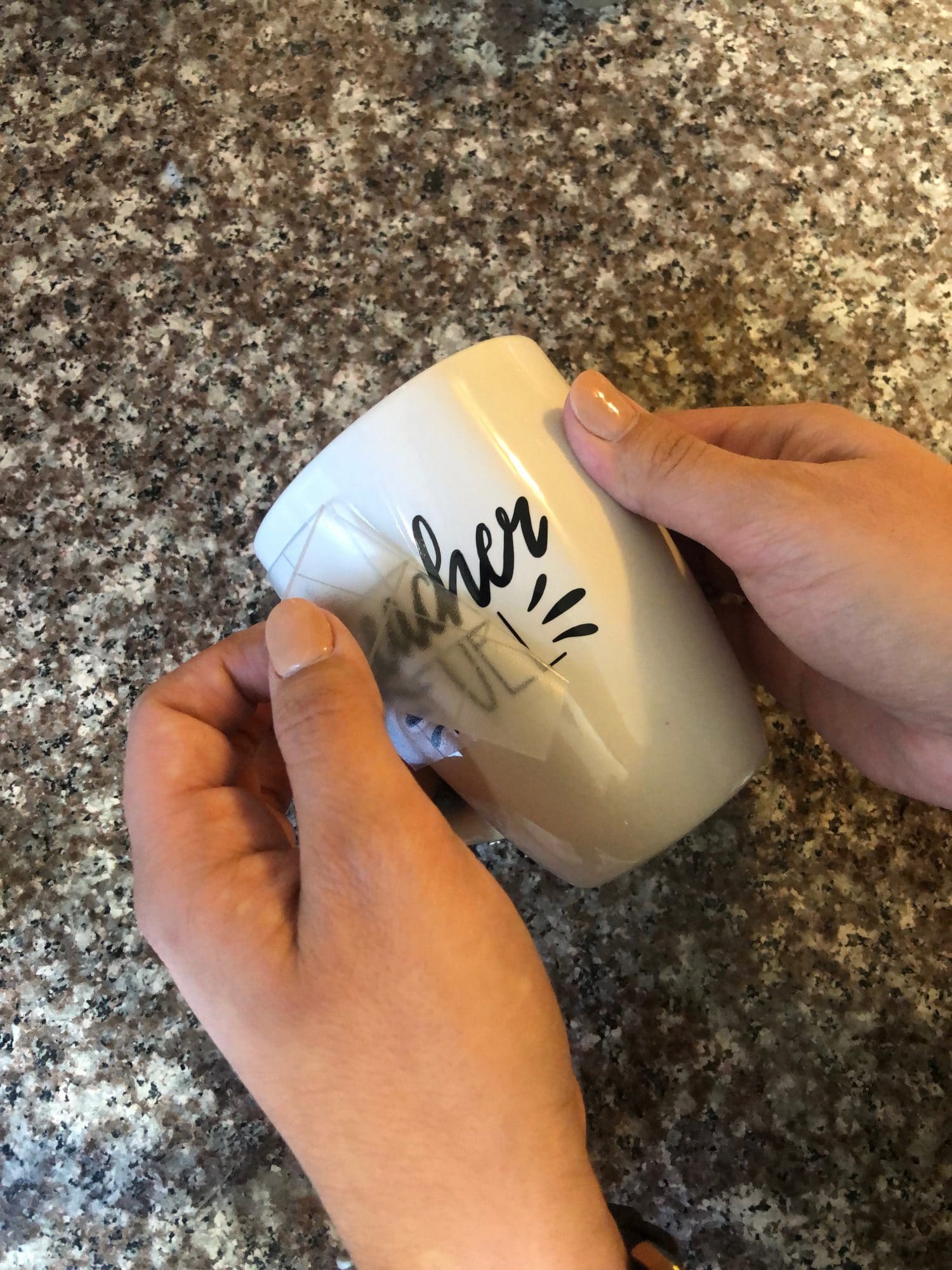 applying design to mug with transfer tape