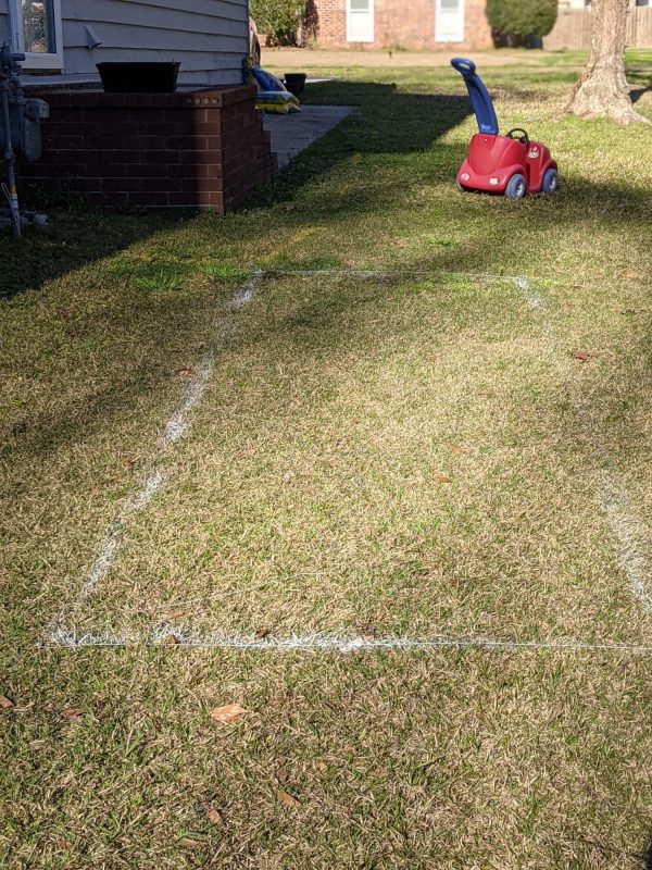 We laid out the garden plot with paint, and with twine to ensure a straight, even line.