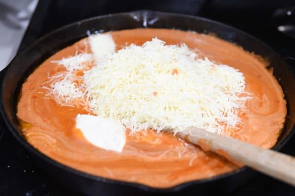 mixing cheeses into sauce