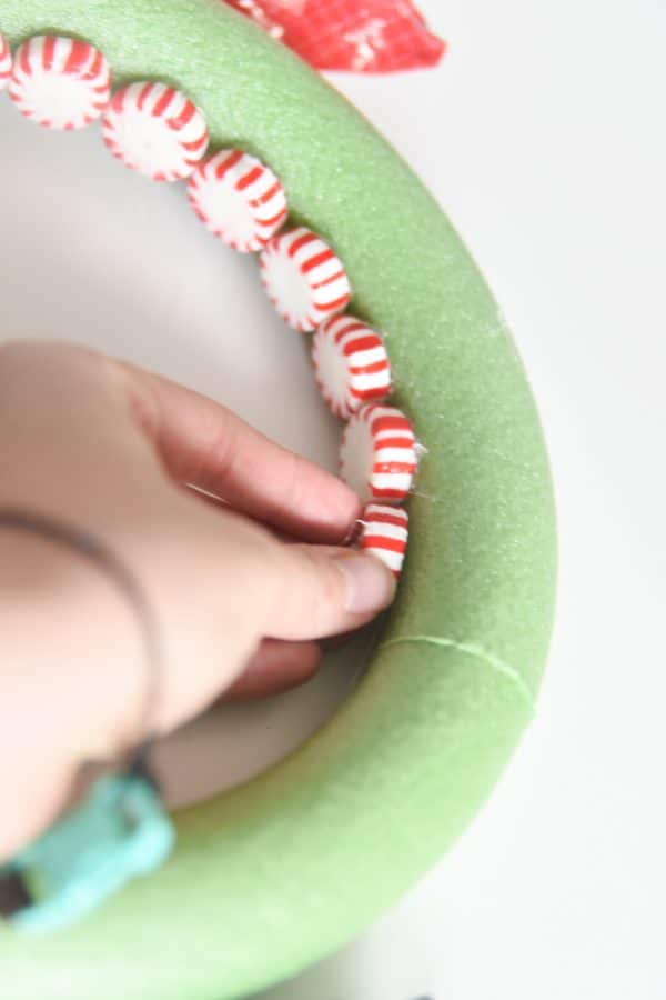 gluing peppermints on wreath