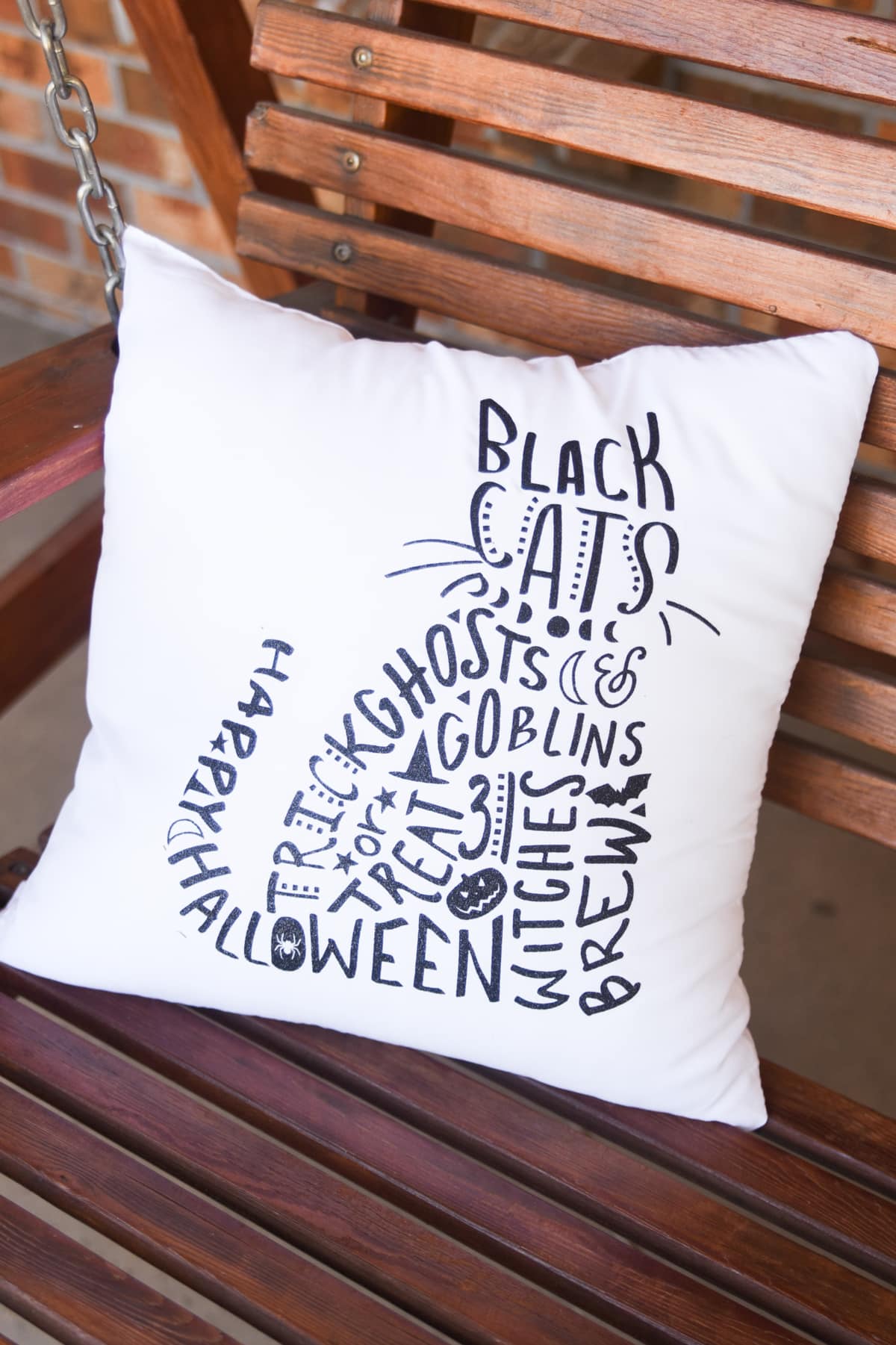 halloween pillow on porch swing