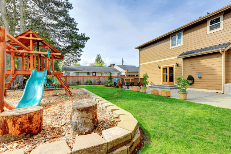 backyard with playground and grass